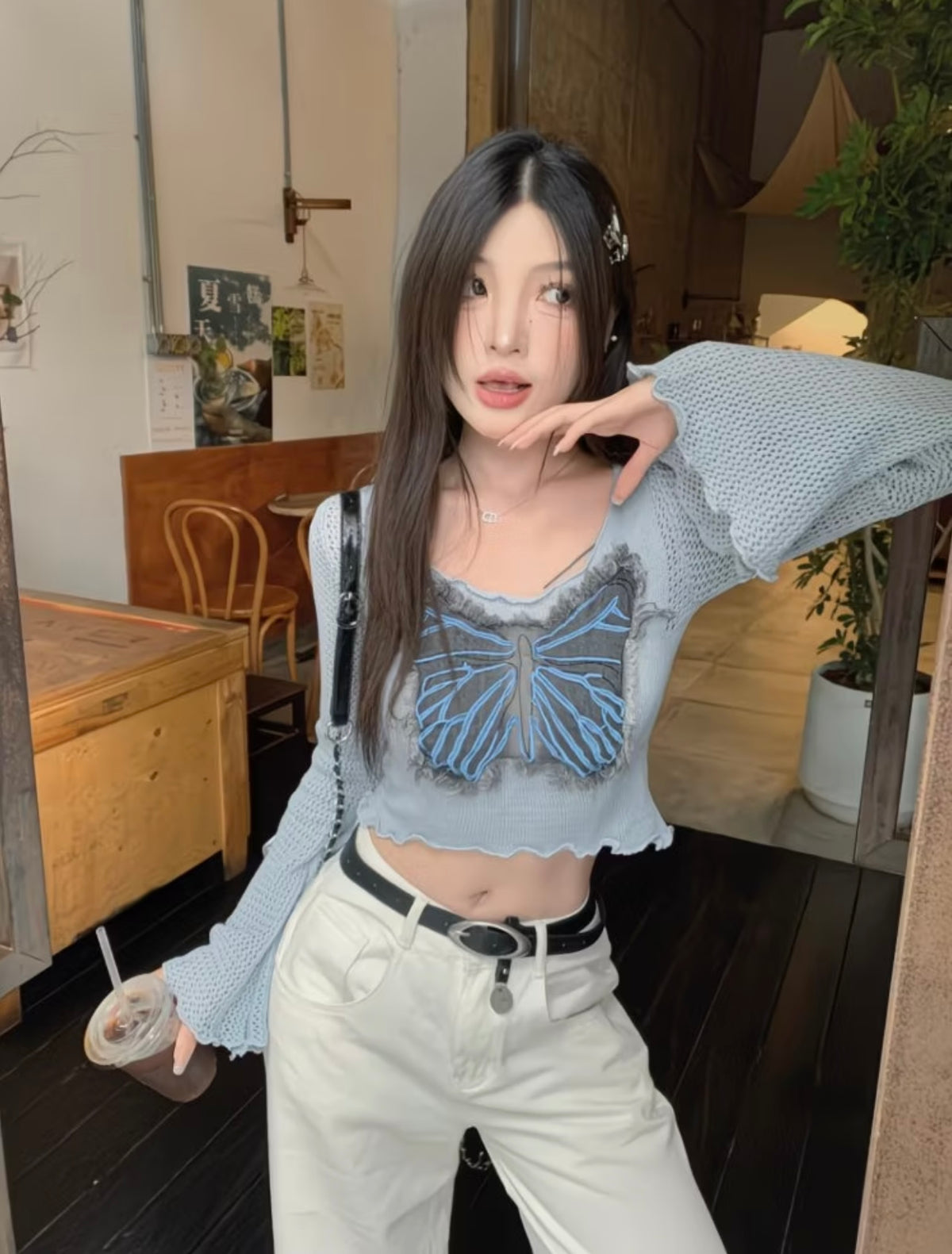 Front view of light blue butterfly knit crop top
